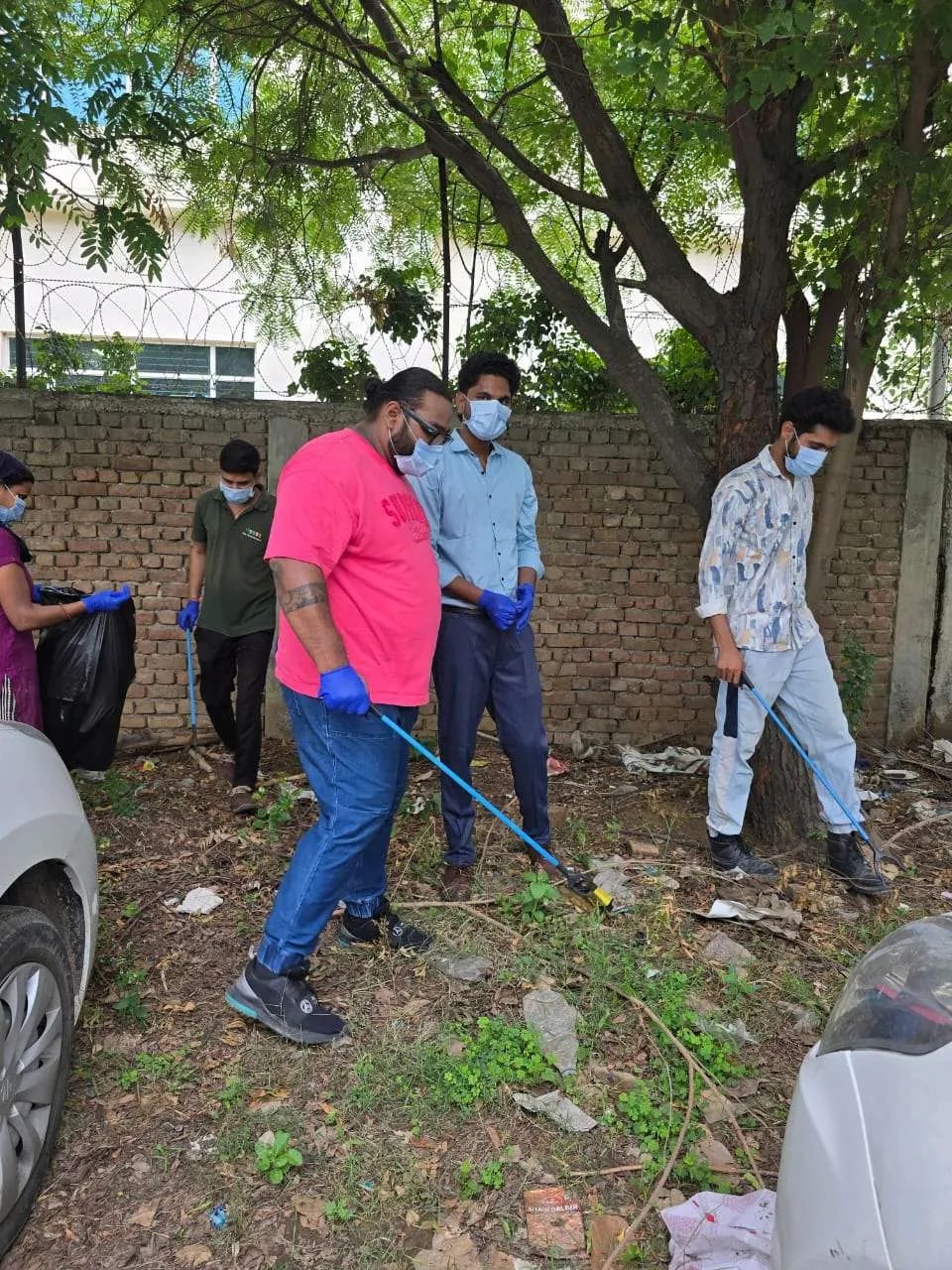 Volunteers with gloves and pickers collecting litter