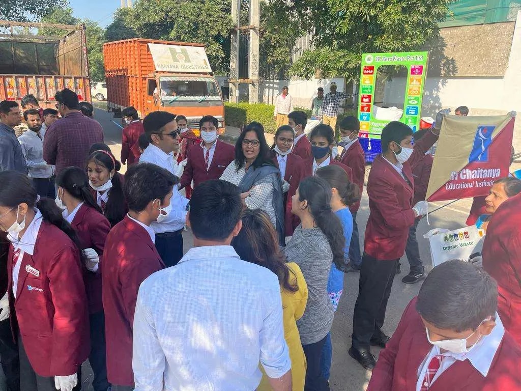 Students in blazers gathered around an exhibit