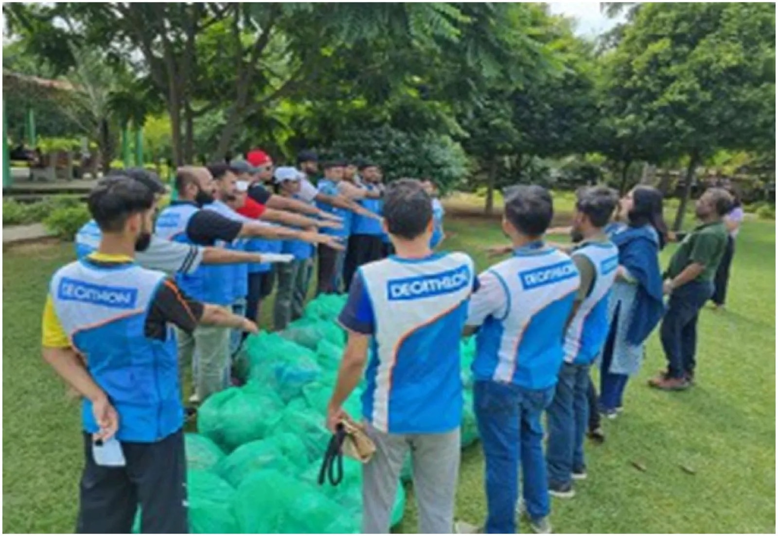 Volunteers beside filled collection bags in a park